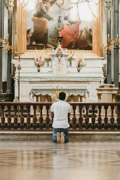Catholic prayer in a church, asking God for financial breakthrough and provision