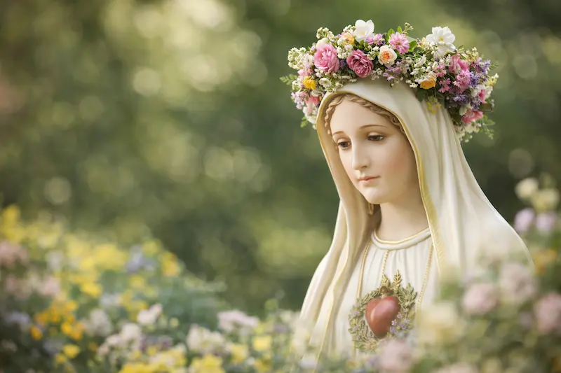 The Blessed Virgin Mary crowned with flowers during the Month of Mary in May, symbol of devotion and prayer
